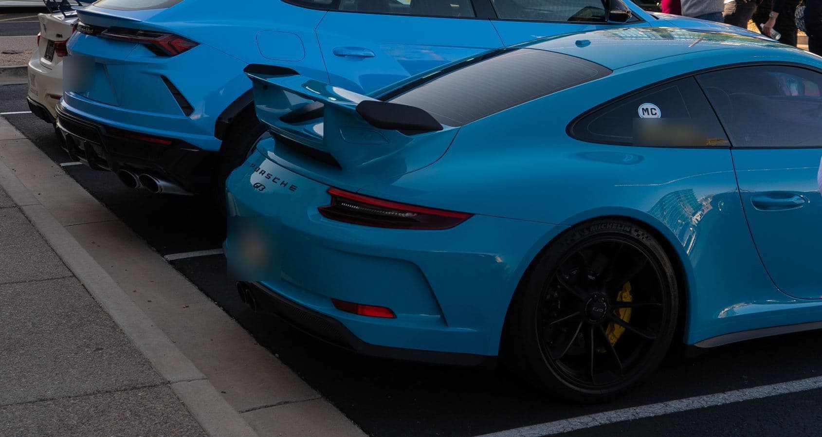 The rear of a blue Porsche 911 GT3 with a fixed wing