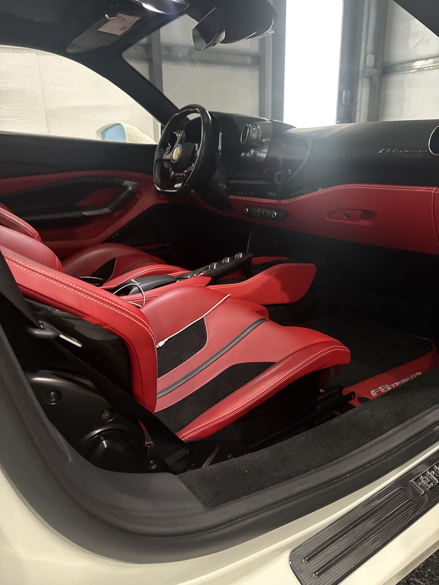 The red and black cabin of a Ferrari F8 Tributo