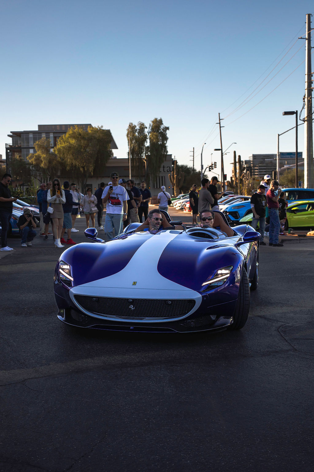 Ferrari Monza SP2 deep blue with white racing stripe, front 3/4 at Hamra car show, crowd behind